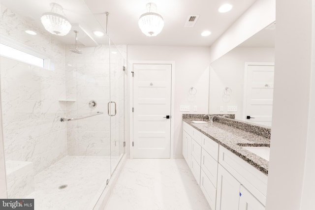 bathroom with a shower with door, double vanity, and tile floors