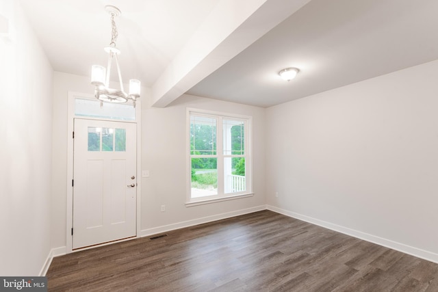 entrance foyer featuring a notable chandelier and dark wood-type flooring