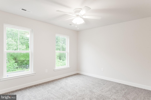 carpeted empty room featuring ceiling fan