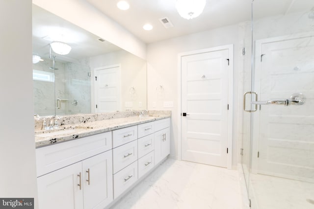 bathroom with double sink, tile floors, large vanity, and a shower with shower door