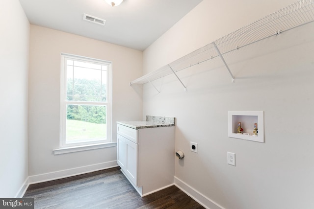 washroom featuring hookup for a washing machine, hookup for an electric dryer, cabinets, and dark hardwood / wood-style flooring