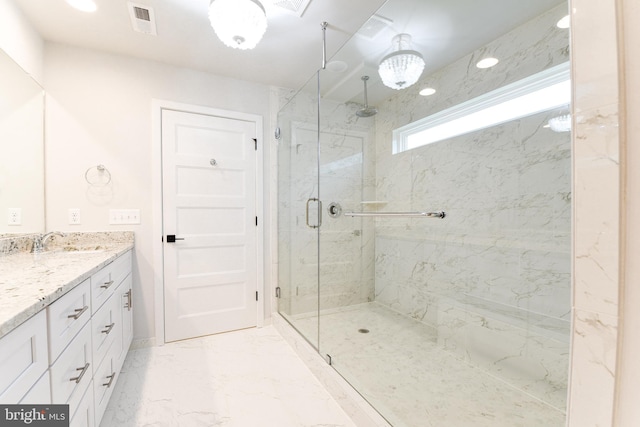 bathroom featuring a shower with door, tile flooring, and vanity