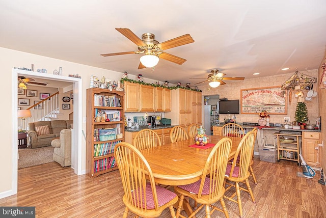 dining room featuring light hardwood / wood-style floors and ceiling fan