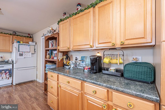 kitchen featuring dark hardwood / wood-style floors and white fridge