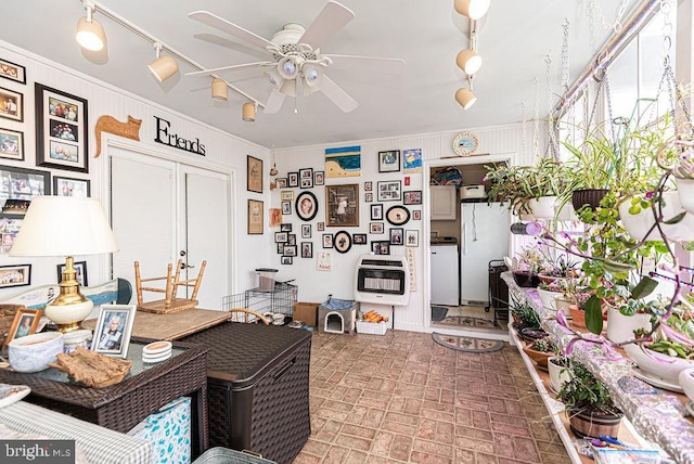 interior space with ceiling fan, crown molding, and rail lighting