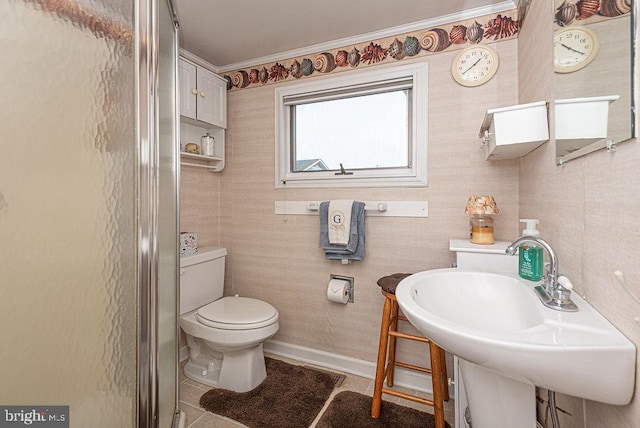 bathroom featuring toilet, tile floors, walk in shower, and sink