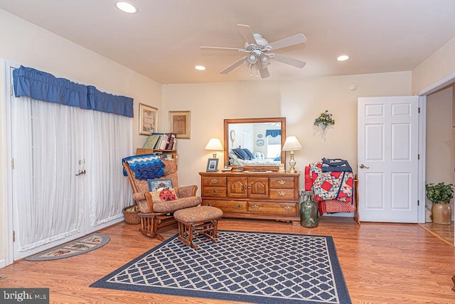 living area featuring ceiling fan and light wood-type flooring