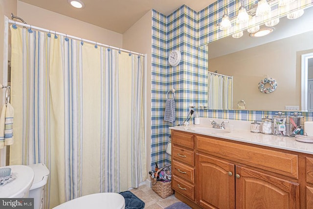 bathroom featuring oversized vanity, toilet, and tile flooring