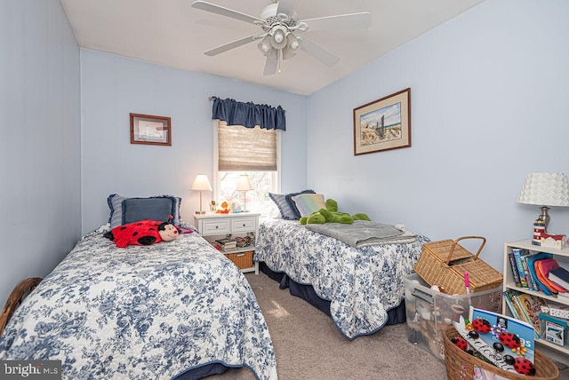 bedroom with ceiling fan and dark carpet