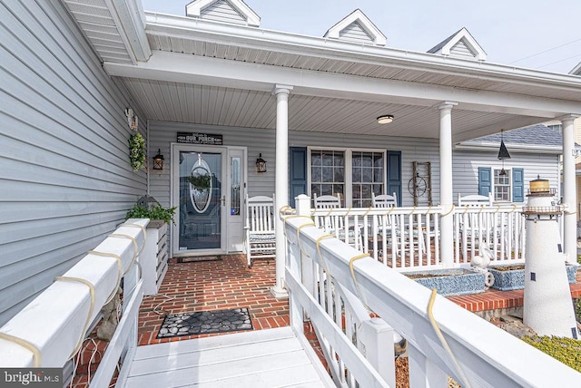 doorway to property featuring covered porch