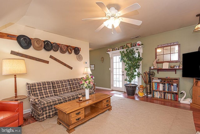 living room featuring light hardwood / wood-style floors and ceiling fan