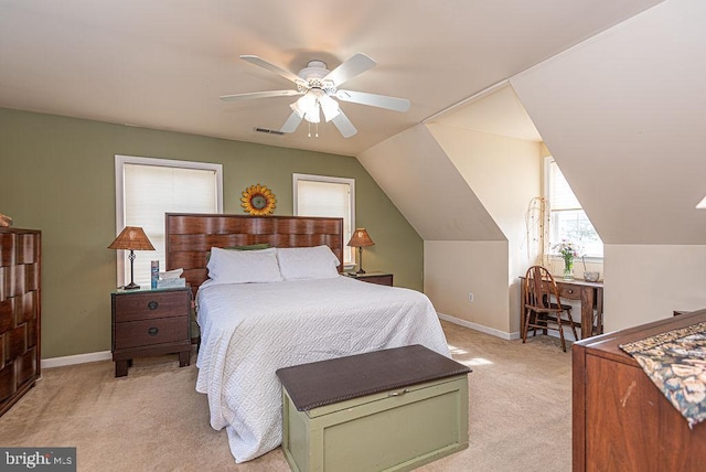 bedroom with ceiling fan, light colored carpet, and vaulted ceiling