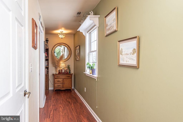 hallway with dark hardwood / wood-style flooring