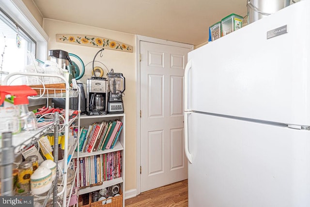 kitchen with white fridge and light wood-type flooring