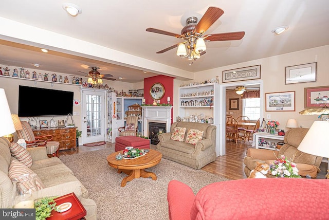 living room featuring plenty of natural light, ceiling fan, and hardwood / wood-style flooring