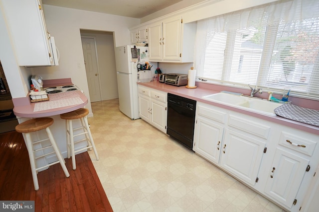 kitchen featuring white cabinets, white appliances, sink, and light tile floors