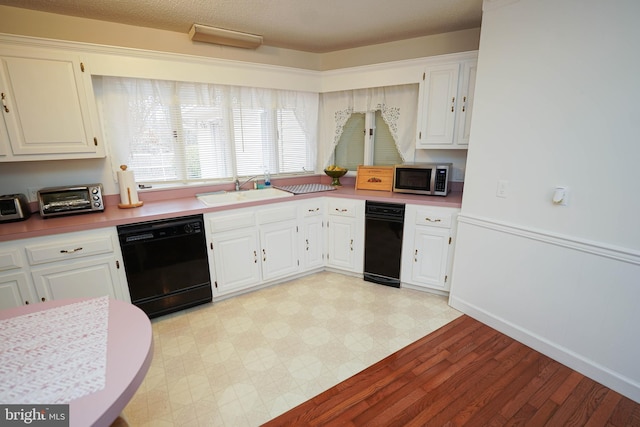 kitchen with white cabinets, sink, dishwasher, and light hardwood / wood-style flooring