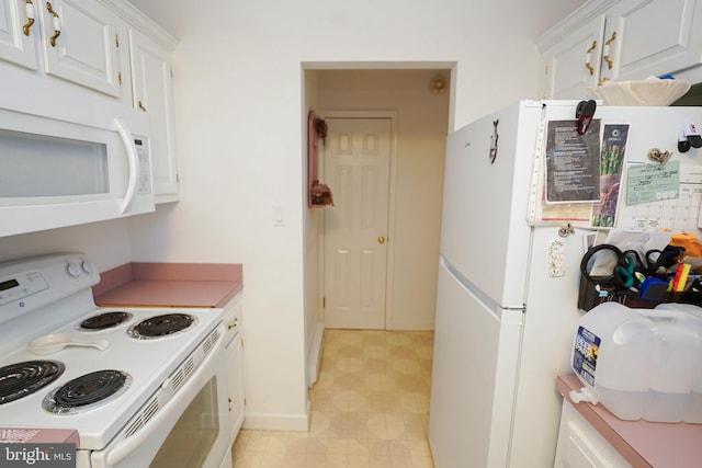 kitchen featuring white cabinets, white appliances, and light tile flooring