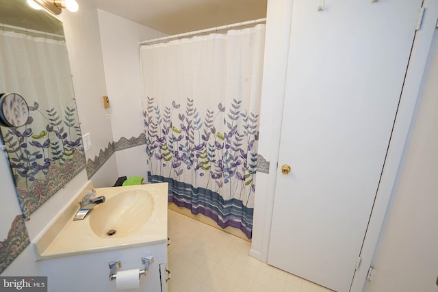 bathroom with tile flooring and vanity