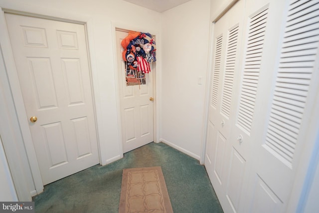 hallway featuring dark carpet