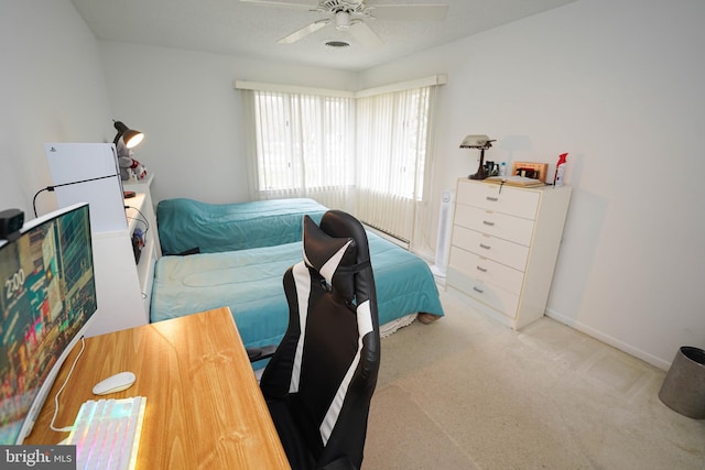 bedroom featuring light carpet and ceiling fan