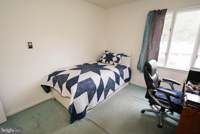 carpeted bedroom featuring multiple windows