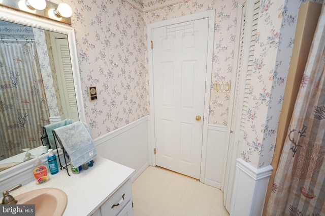 bathroom with tile floors and vanity