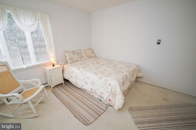 bedroom with carpet flooring and baseboard heating