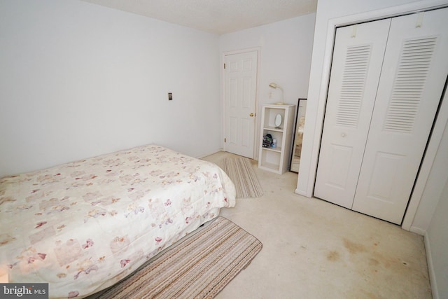 carpeted bedroom featuring a closet