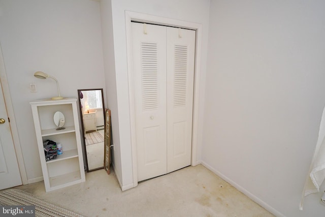 unfurnished bedroom featuring a closet and carpet floors