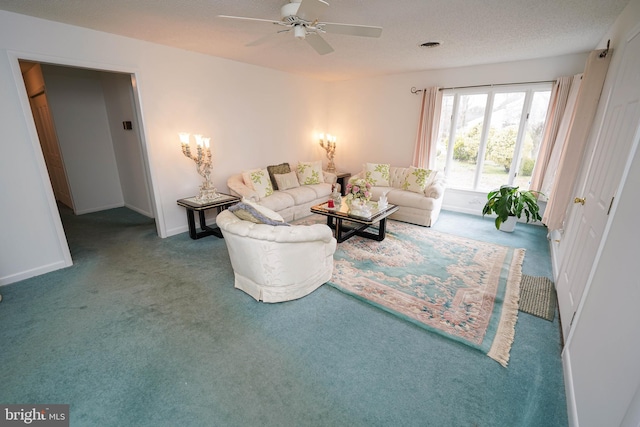 living room with ceiling fan and dark carpet