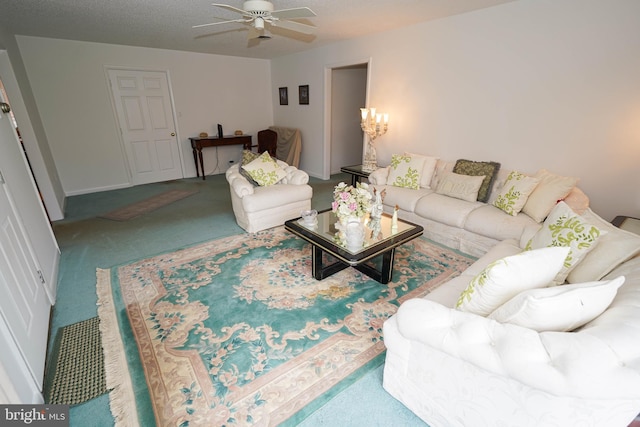 carpeted living room featuring ceiling fan and a textured ceiling