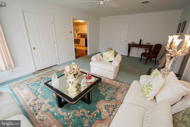 carpeted living room featuring ceiling fan