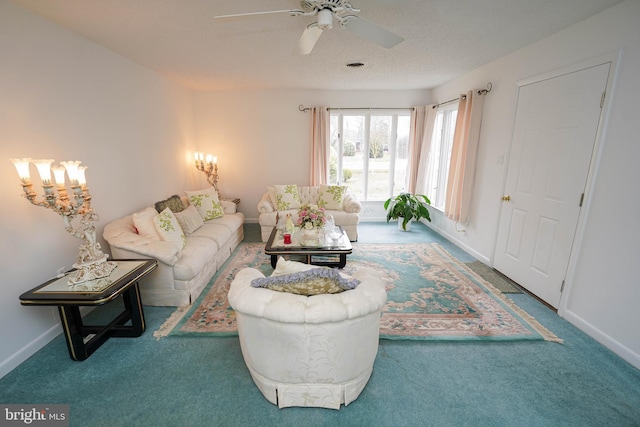 carpeted living room with ceiling fan