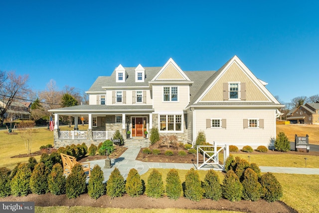 view of front of home with a porch and a front yard