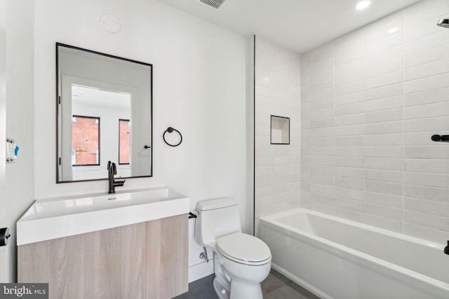 full bathroom with vanity, toilet, and tiled shower / bath