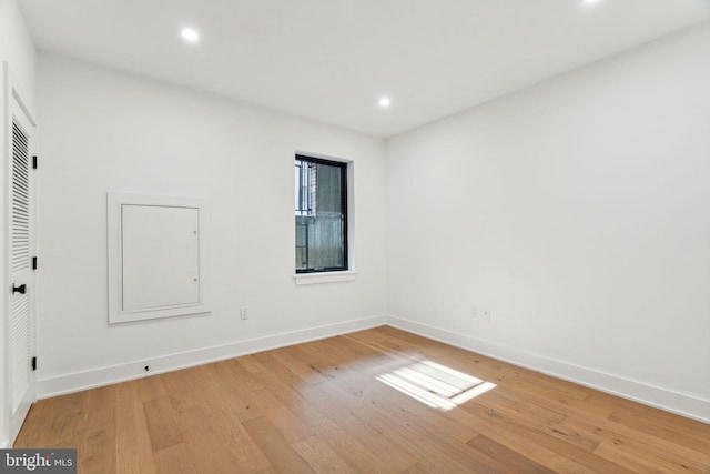 spare room with light hardwood / wood-style flooring