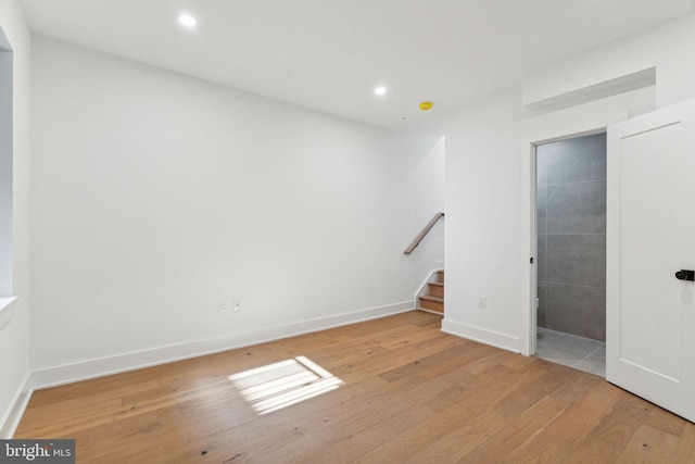 interior space with ensuite bath and light hardwood / wood-style floors