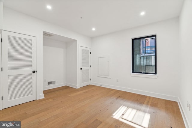 spare room featuring light wood-type flooring