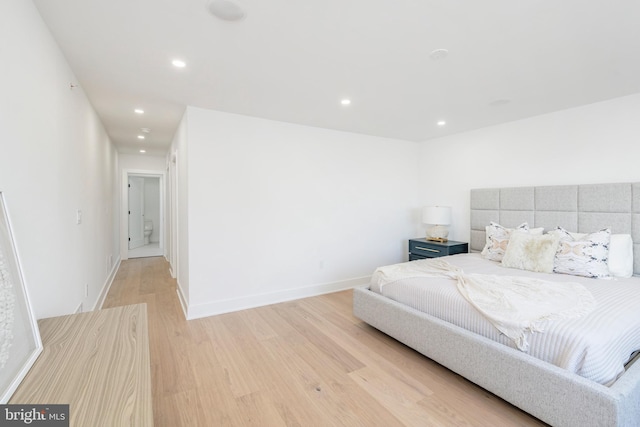 bedroom with hardwood / wood-style flooring