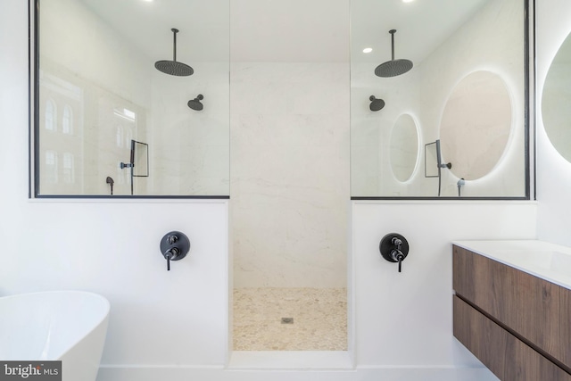 bathroom featuring shower with separate bathtub and vanity