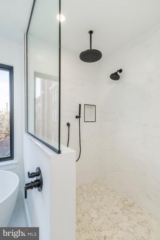 bathroom featuring shower with separate bathtub and sink