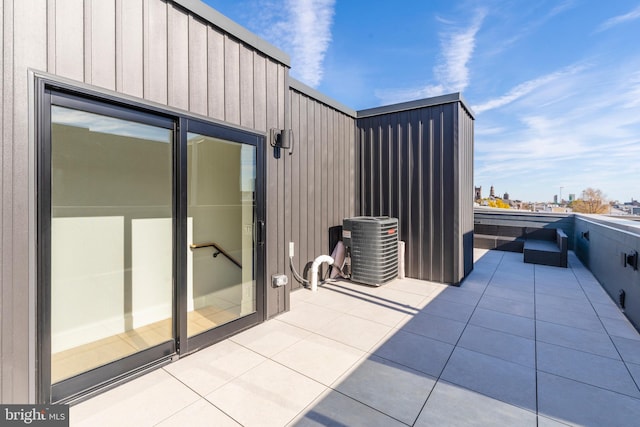 view of patio featuring central AC and a balcony