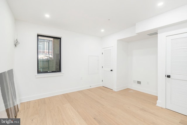 empty room with light hardwood / wood-style flooring