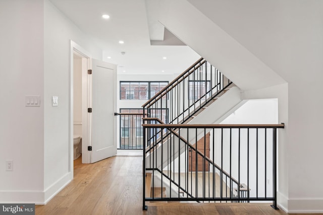 stairs featuring light hardwood / wood-style floors