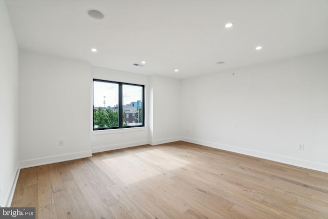 unfurnished room with light hardwood / wood-style floors