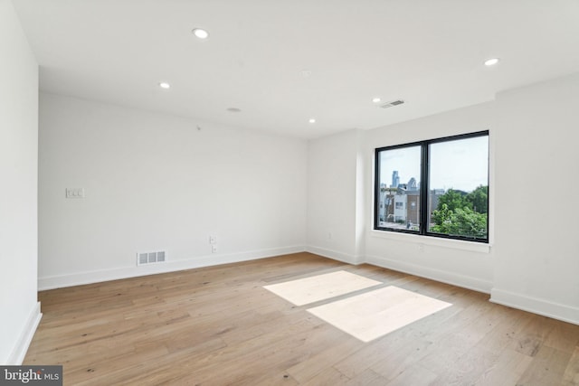 spare room with light wood-type flooring