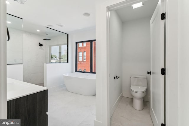 bathroom featuring vanity, toilet, and a washtub