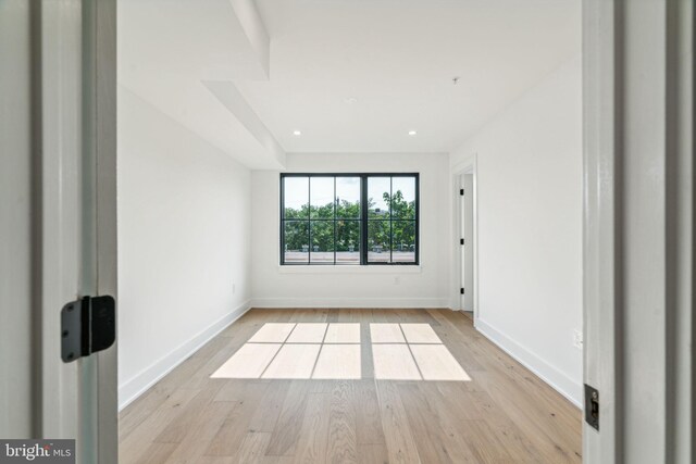 spare room featuring light hardwood / wood-style flooring