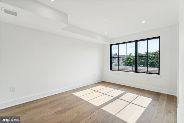 empty room with light hardwood / wood-style flooring